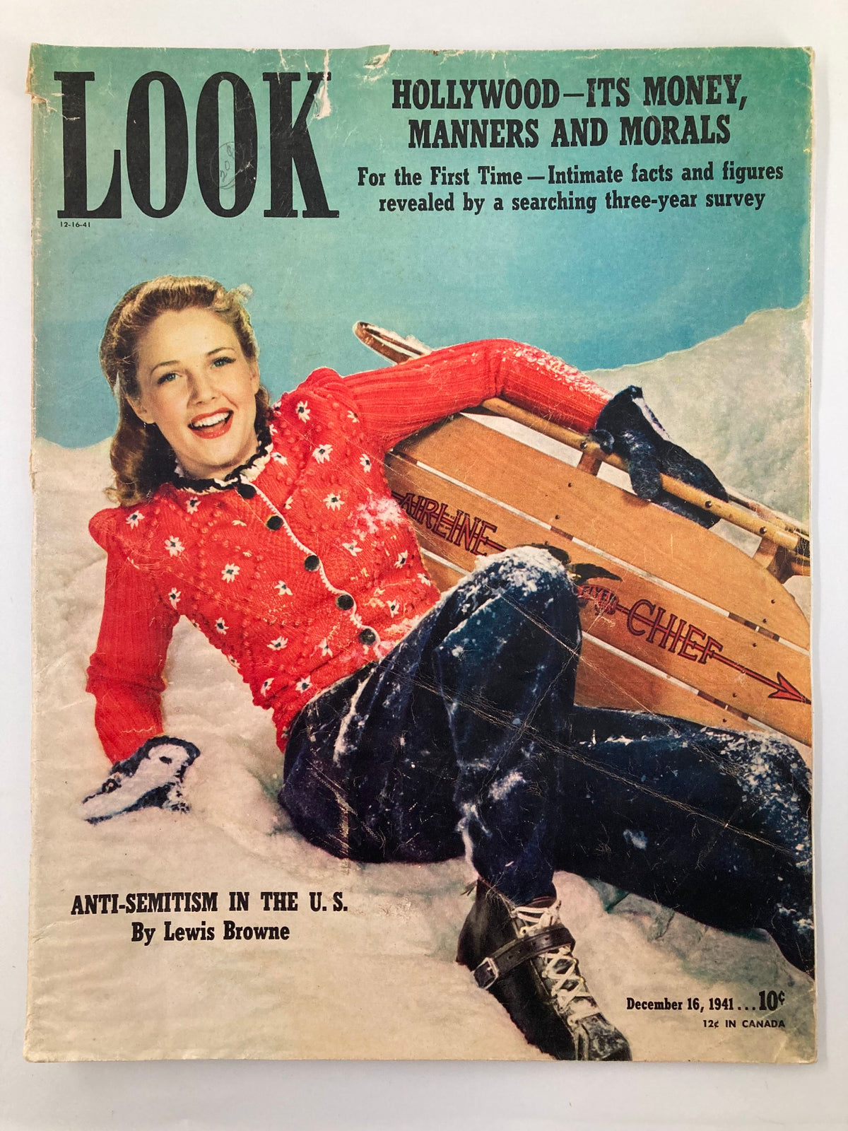 Cover of VTG Look Magazine December 16, 1941 featuring Barbara Britton in a snowy scene, wearing a red sweater and sitting on a sled, representing vintage style and 1940s culture.