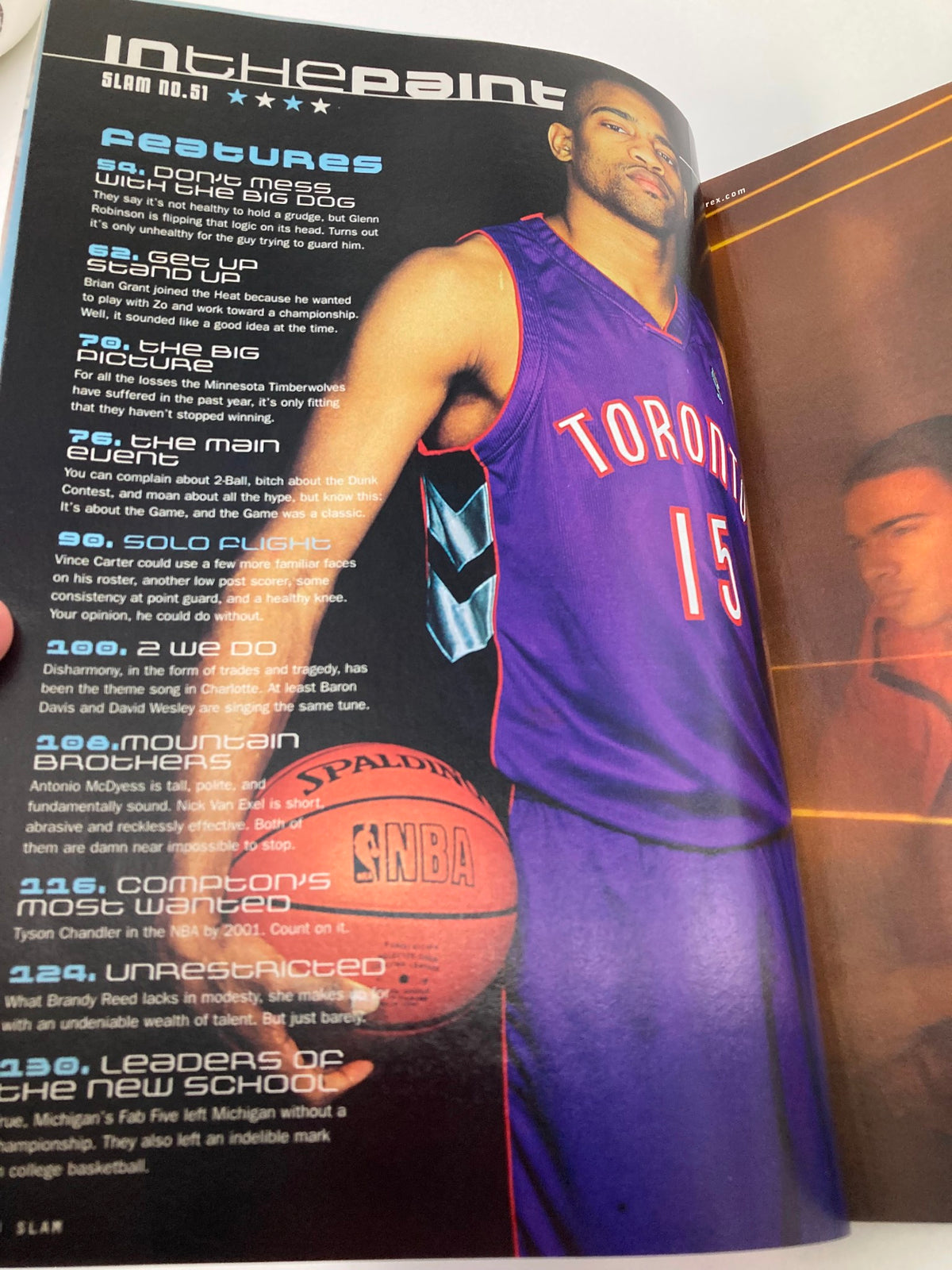 Page from Slam Magazine May 2001 featuring a Toronto Raptors player in a purple jersey, showcasing basketball-related content and ads.
