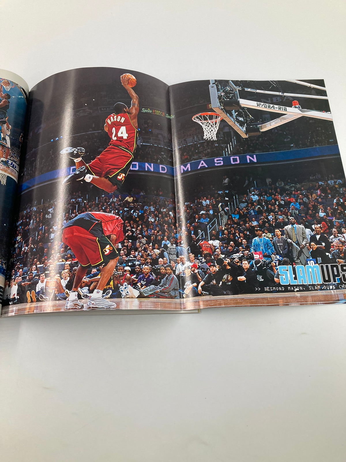 Action shot from Slam Magazine May 2001, featuring a basketball game moment, showcasing an intense dunk by a player wearing a red jersey.
