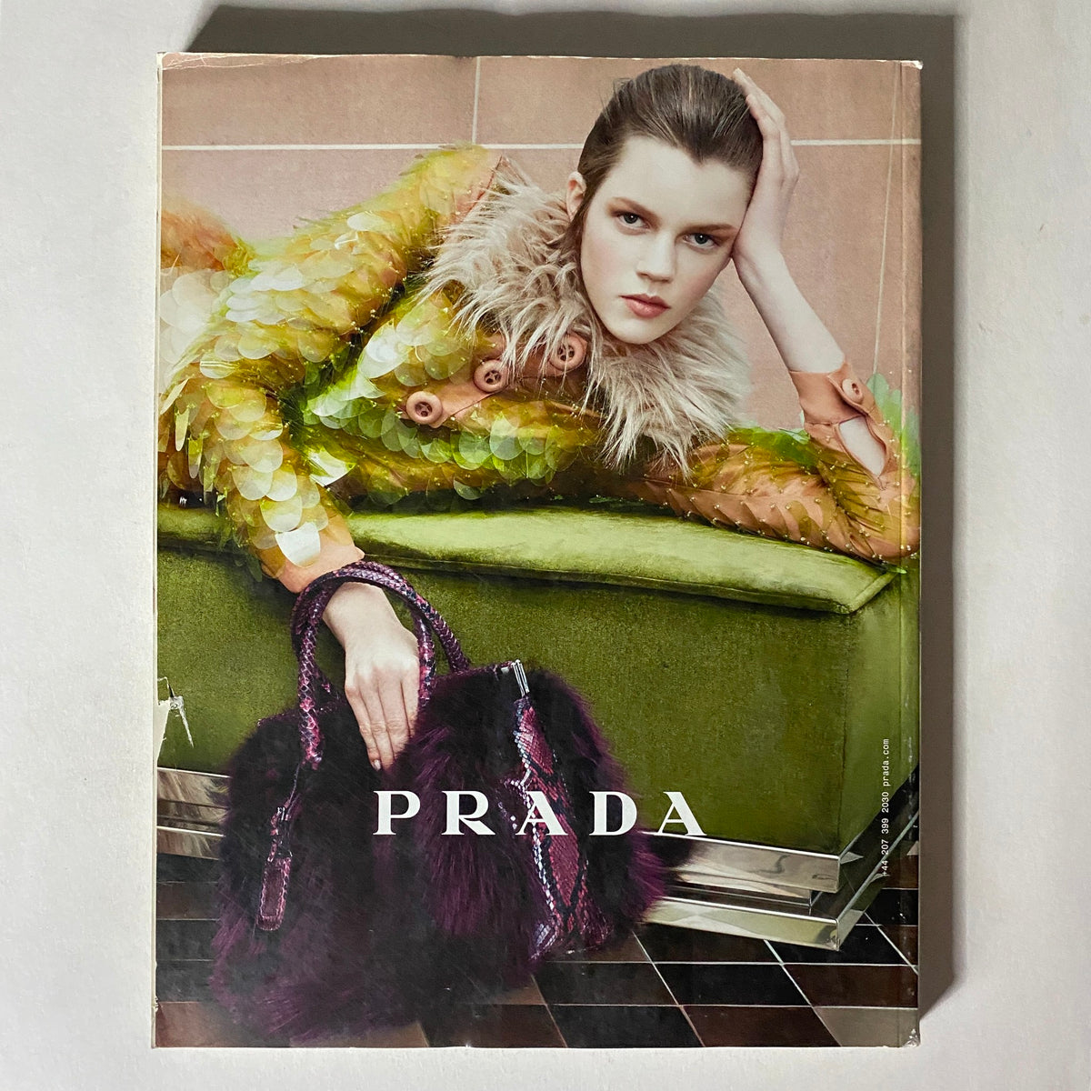 Back cover of i-D Magazine Fall 2011 No. 314, featuring a glamorous ad for Prada with a model in a stylish outfit.