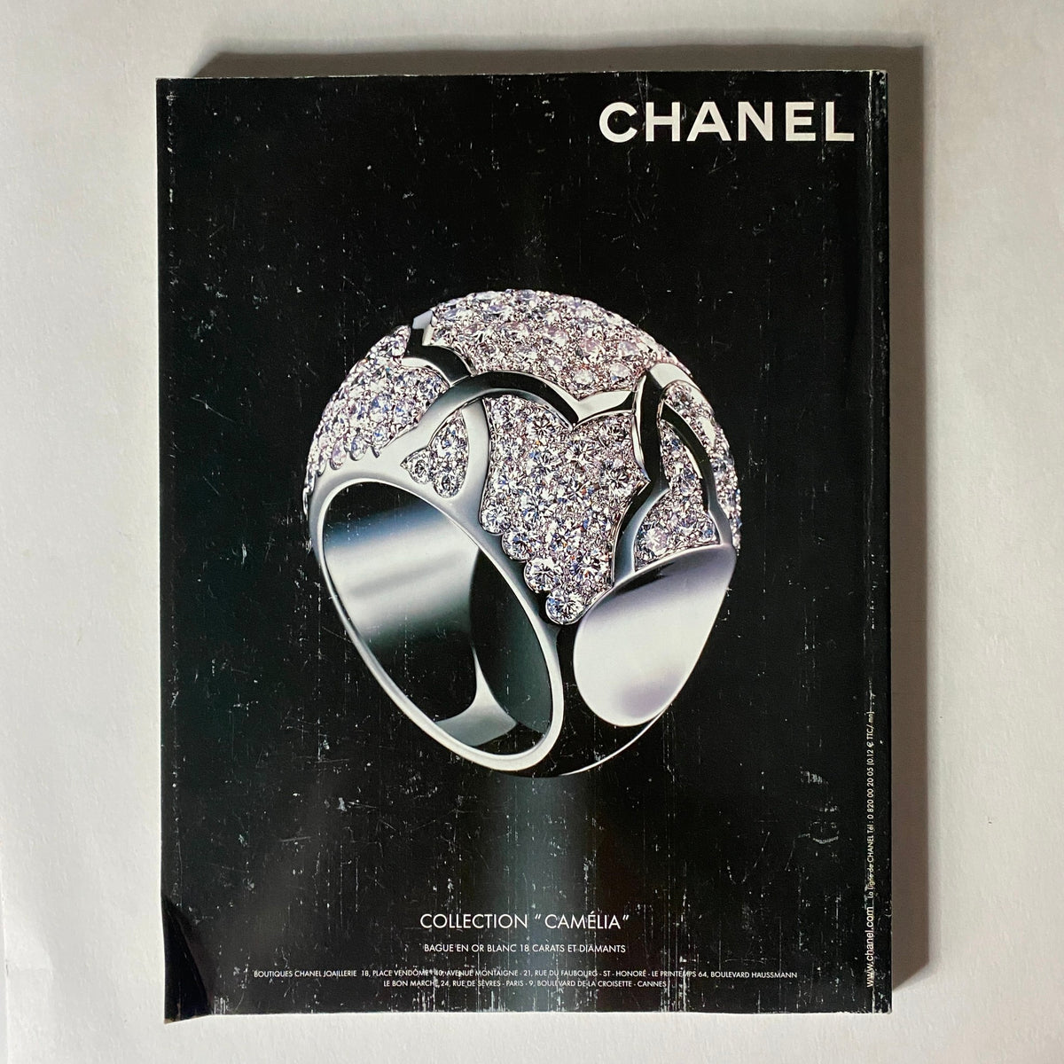 Vogue Paris Magazine March 2005 showcasing a luxurious Chanel Camélia ring on a black background, highlighting high-end jewelry design.