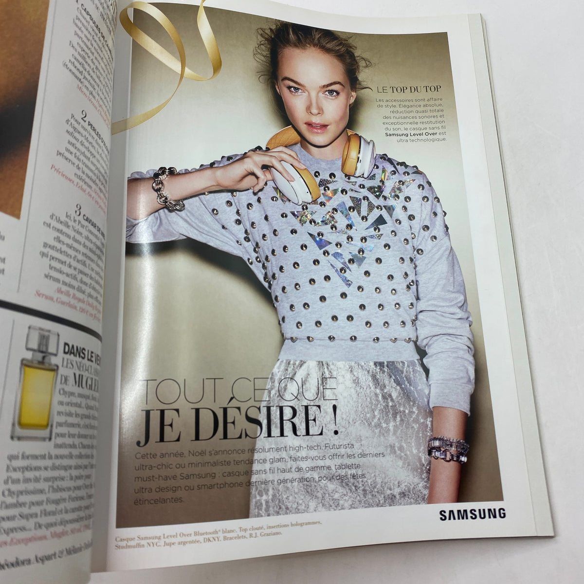 Advertising page from Vogue Paris Magazine December 2014 featuring a stylish model promoting Samsung, capturing modern fashion trends.