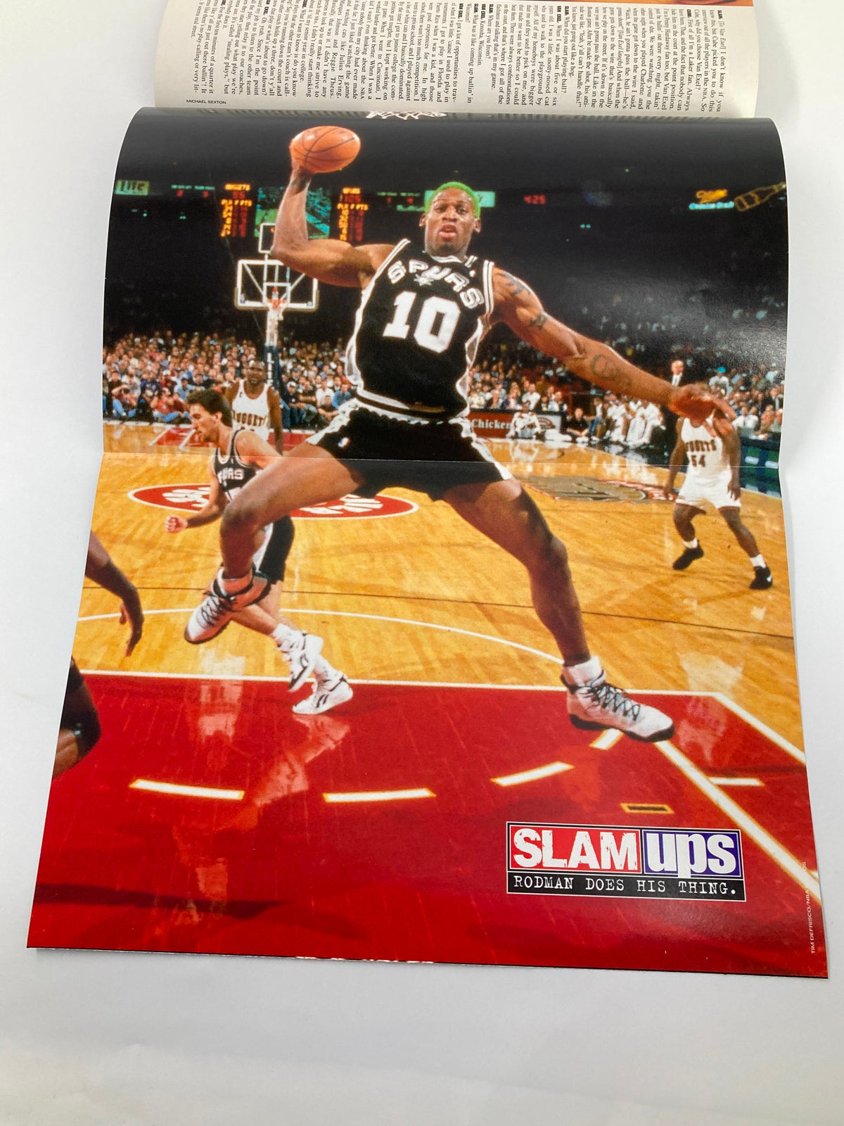 Pull-out poster from Slam Magazine July 1995 showcasing Dennis Rodman in action, emphasizing his dynamic playing style with vibrant colors.