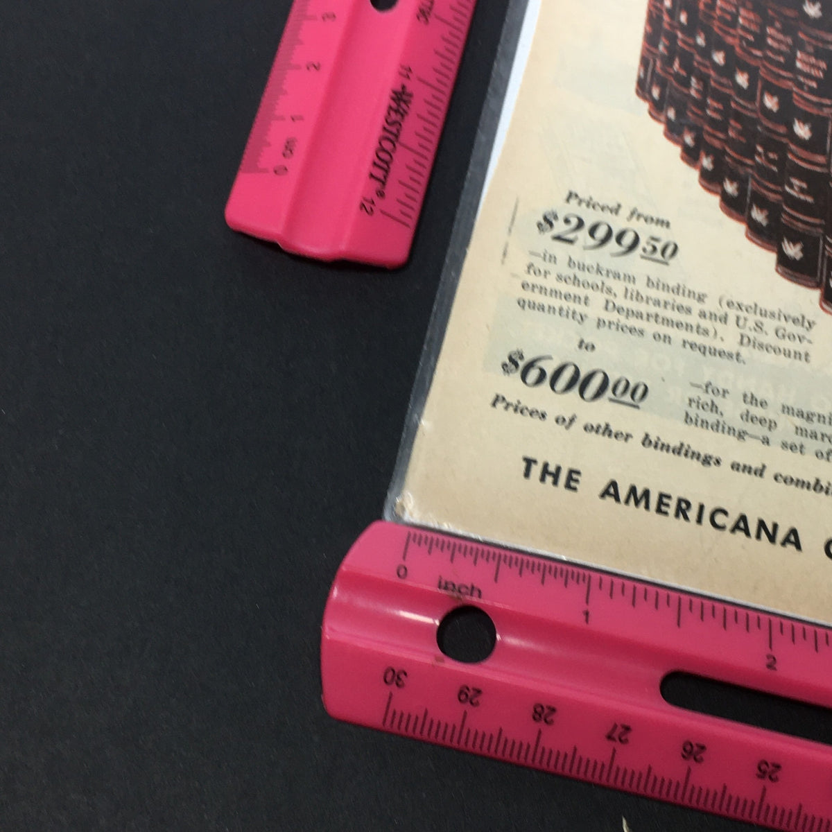 Detailed close-up of pricing on the VTG 1957 The Americana Corporation Encyclopedia Abraham Lincoln Print Ad, featuring vintage price listings for the Encyclopedia Americana.
