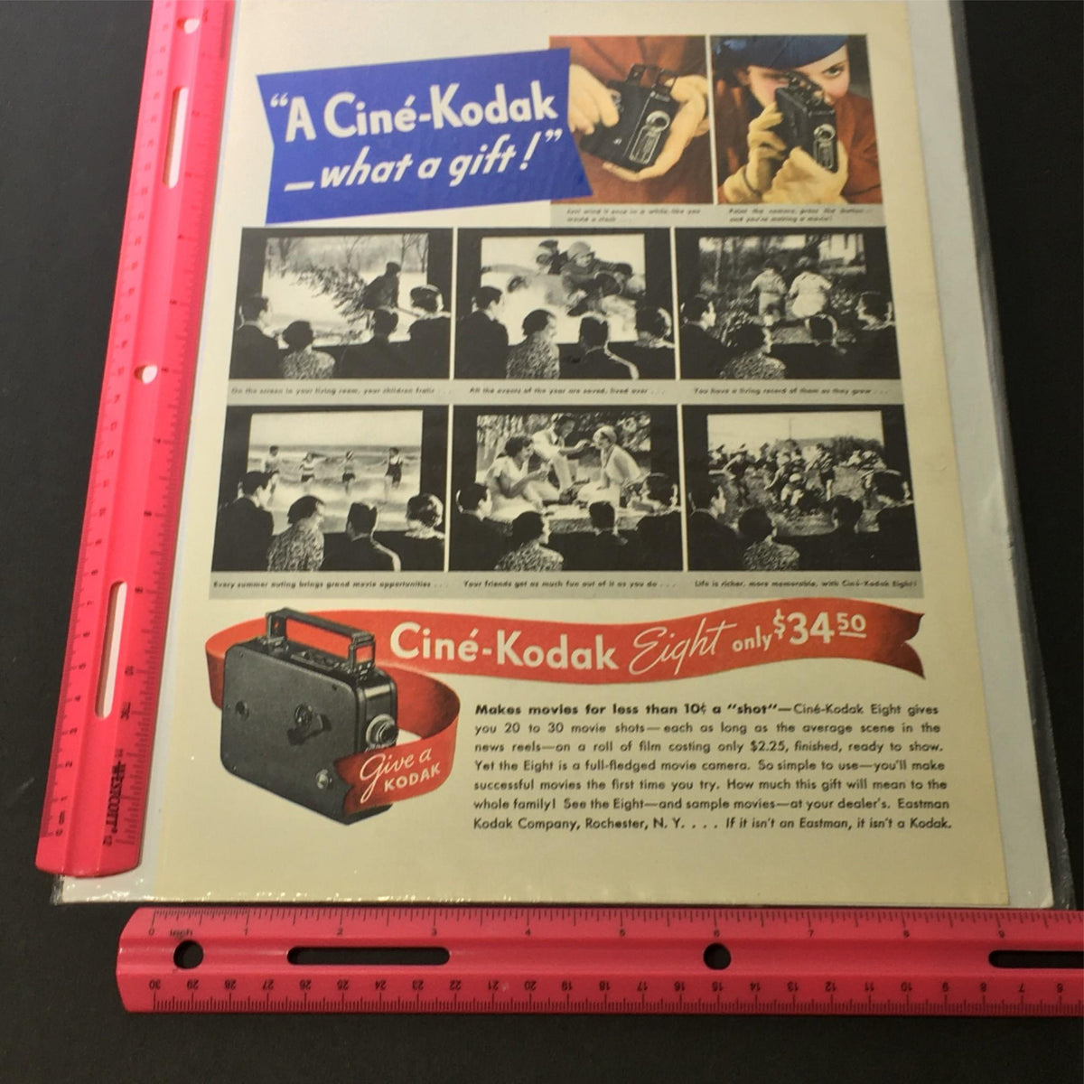 Detailed view of the VTG 1929 Cine-Kodak Eight Model BB for 50-ft reels Print Ad featuring a camera and scenes with a ruler for size reference.