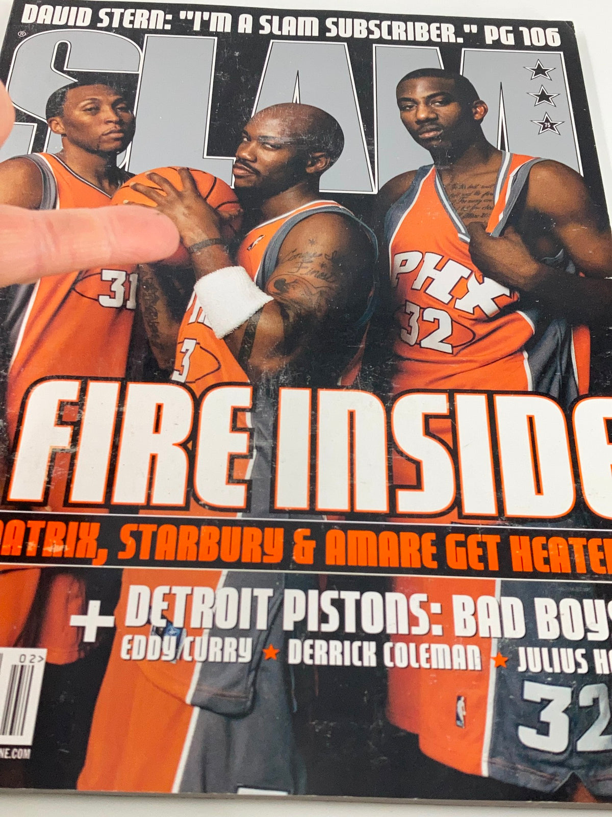 Close-up view of Slam Magazine February 2004 cover showing Amar'e Stoudemire, Shawn Marion, and the title 'A Fire Inside'. A collectible for basketball fans.