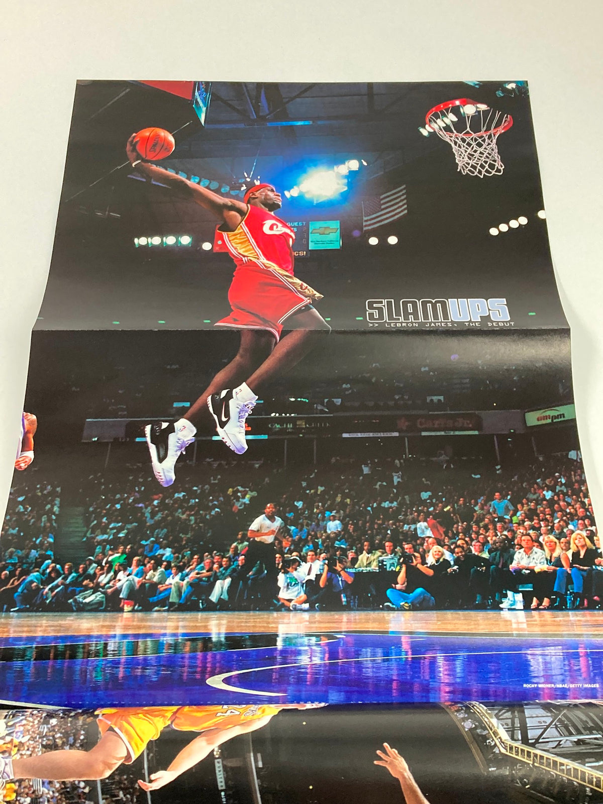 Poster from Slam Magazine February 2004 showcasing a dynamic basketball dunk. Includes a visual representation of the energy and excitement of early 2000s basketball.