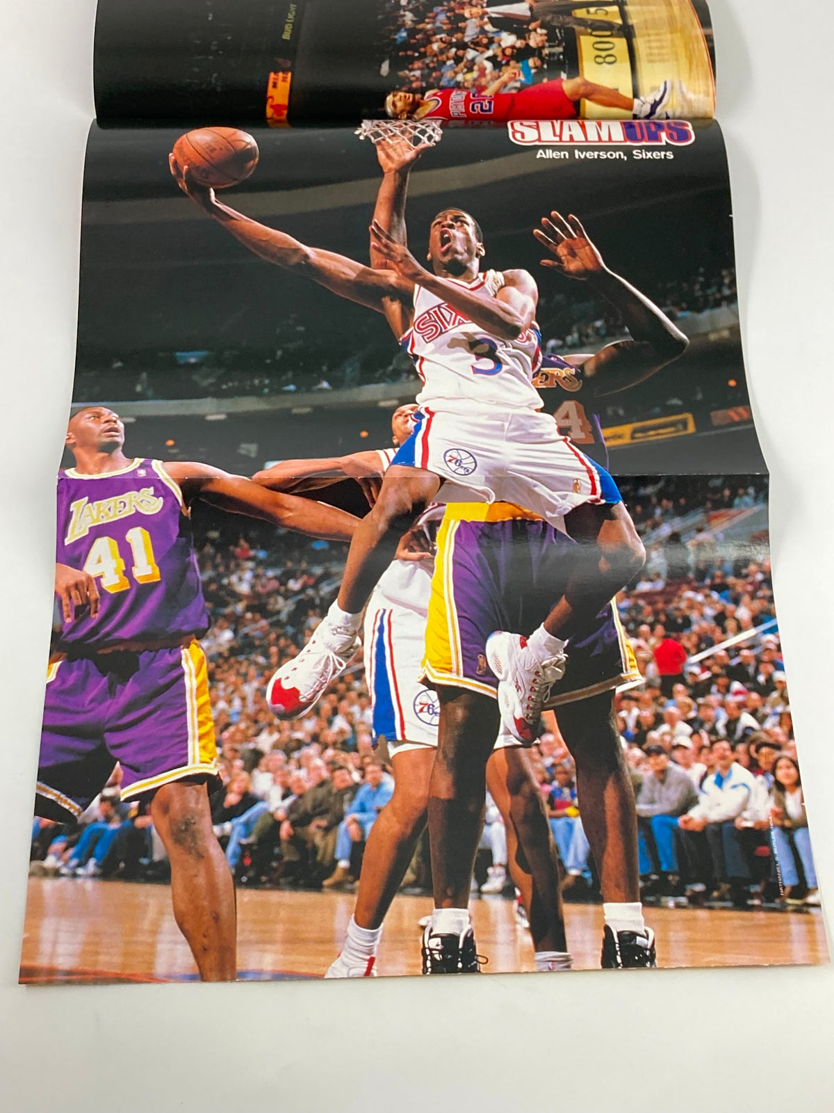 Slam Magazine March 1997 page featuring Allen Iverson of the Sixers, mid-action shot during a game against the Lakers.
