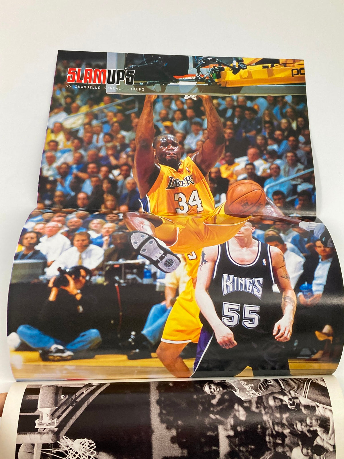 Fold-out poster from Slam Magazine December 2001 featuring Shaquille O'Neal in action, showcasing the excitement of NBA players during the season.