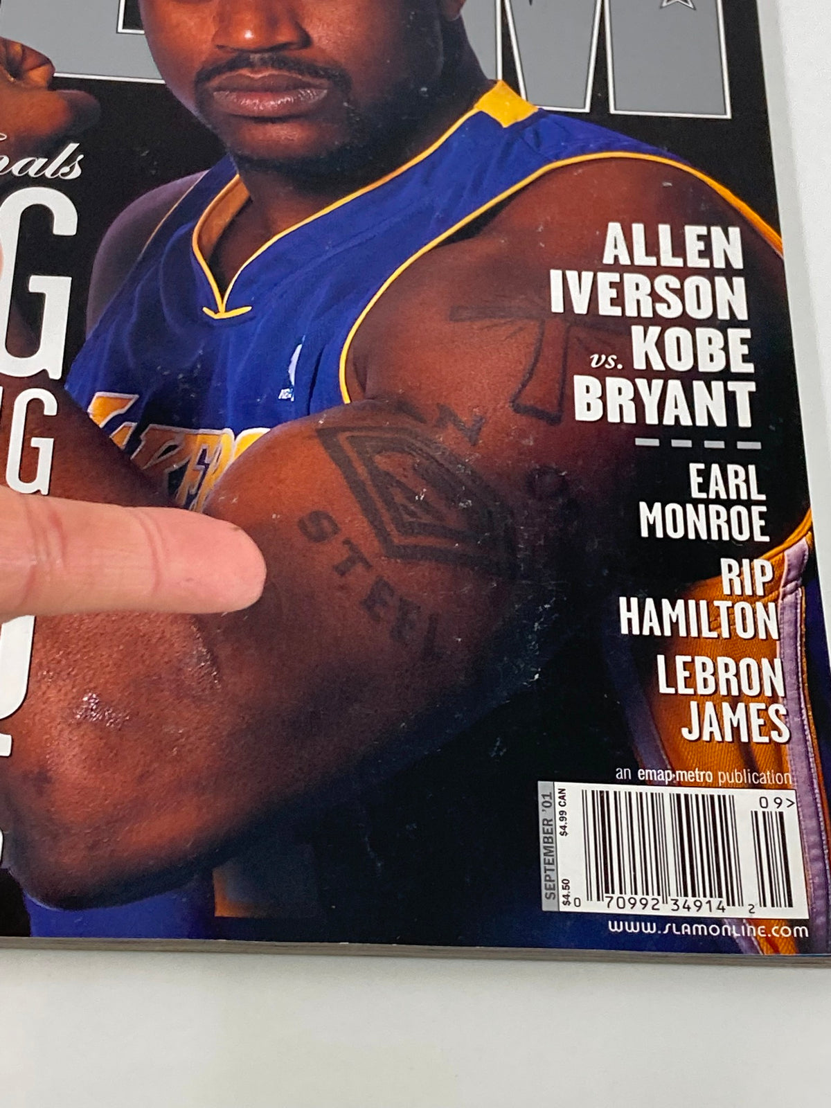 Close-up of Shaquille O'Neal's arm tattoo on the cover of Slam Magazine September 2001, showcasing his muscular build and detailed ink.