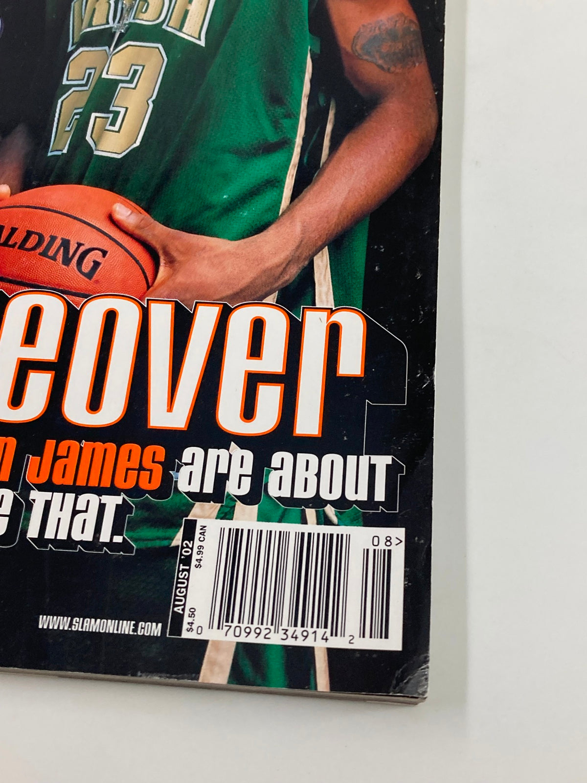 Slam Magazine August 2002 featuring LeBron James on the cover, showcasing his early basketball career and collectibles for fans.