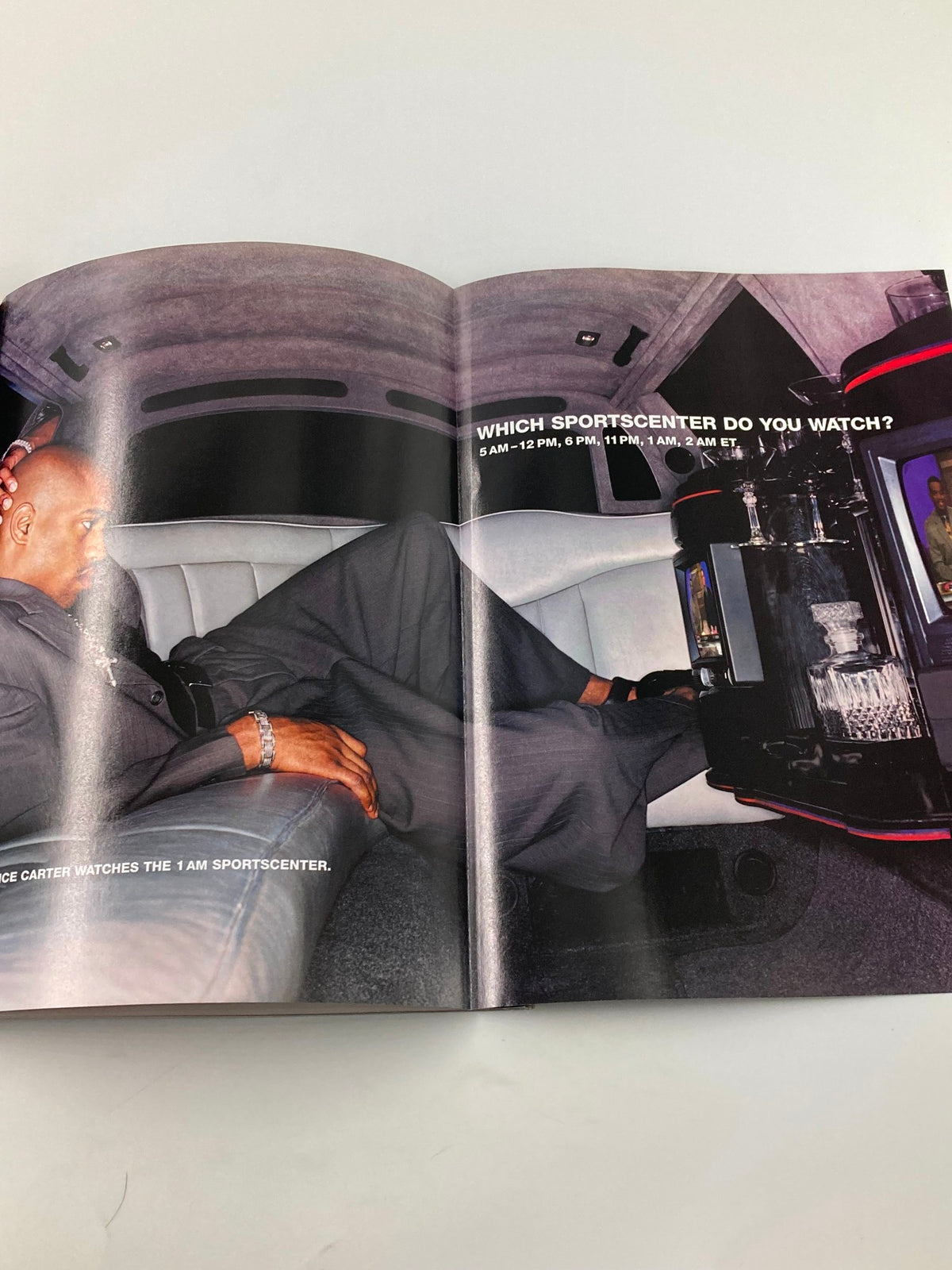 Inside view of Slam Magazine June 2001, displaying a stylish basketball player relaxing in a luxury vehicle.