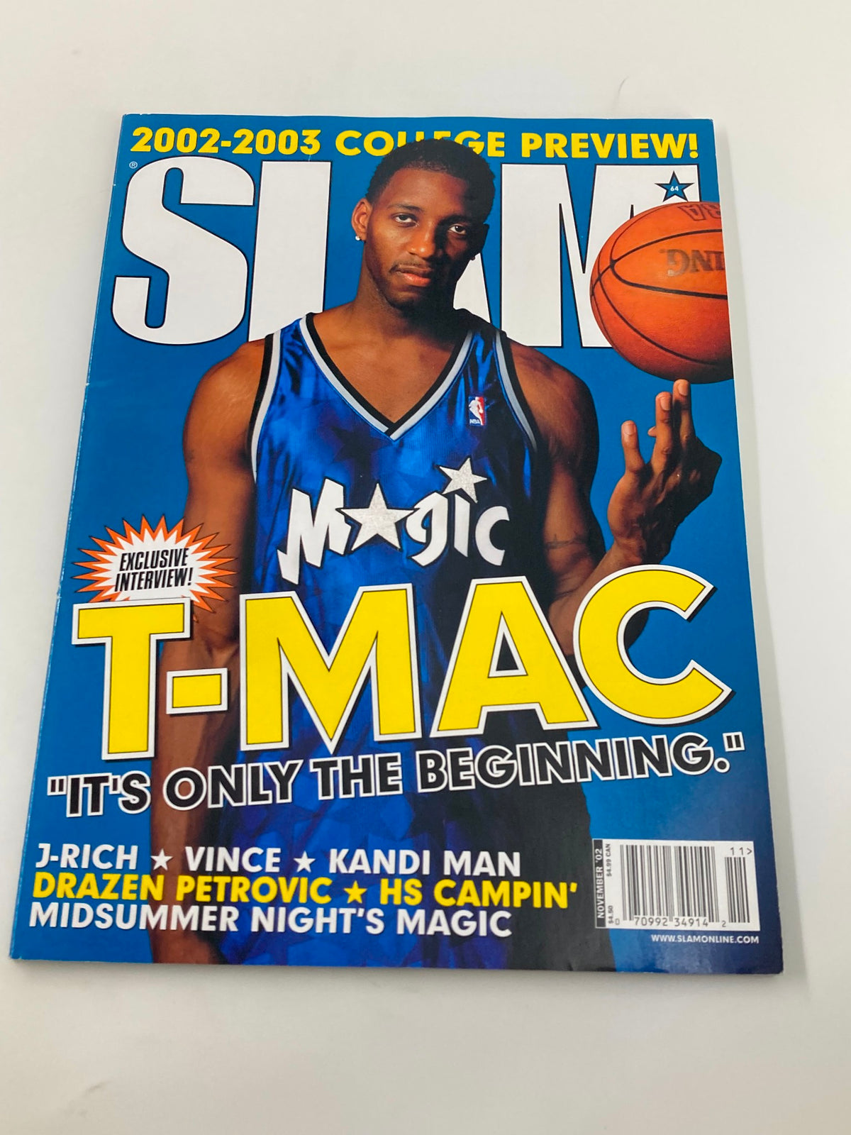 Slam Magazine November 2002 with Tracy McGrady on the cover, emphasizing the early 2000s basketball scene and the star's rise to prominence.