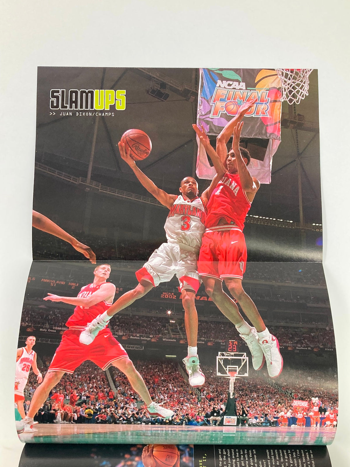 Another poster from Slam Magazine June 2002 featuring a dynamic basketball play during the NCAA Final Four. This visually stunning photo emphasizes the excitement and intensity of basketball.