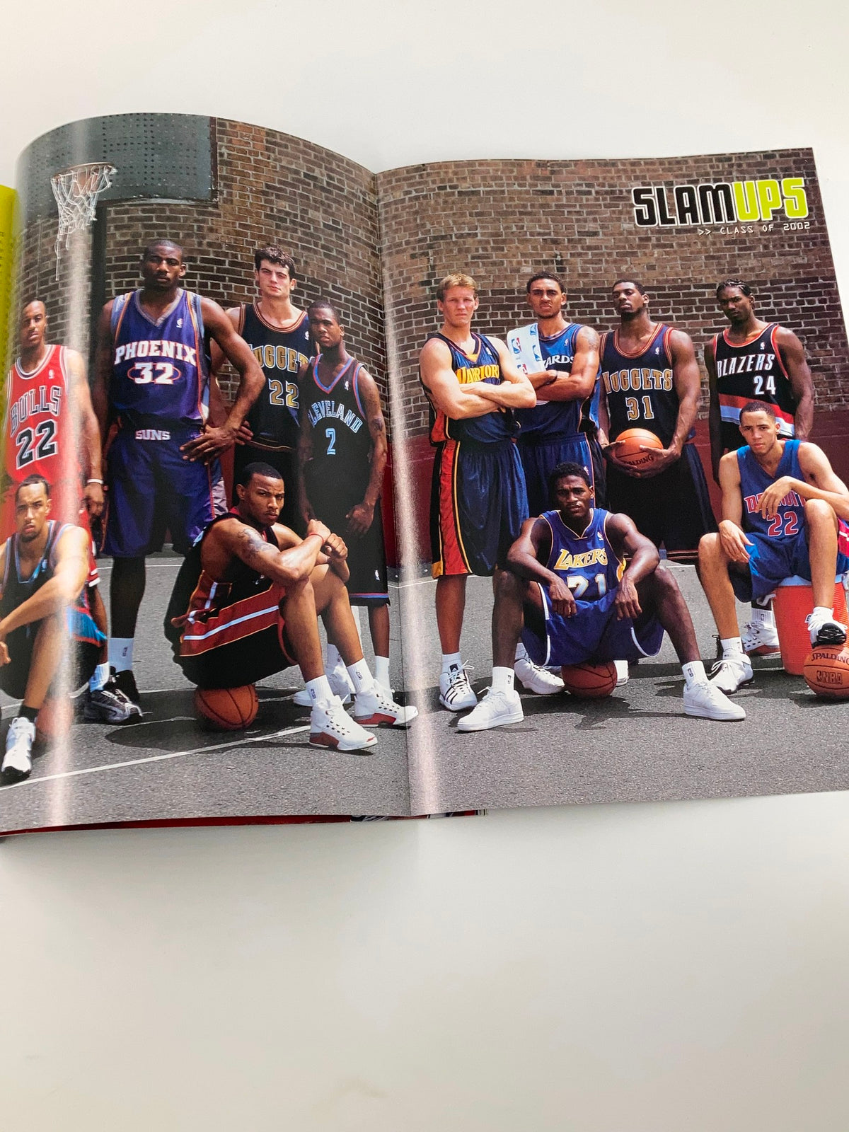 Inside spread of Slam Magazine December 2002 showcasing an ensemble of NBA players in jerseys, emphasizing talent and teamwork in basketball.