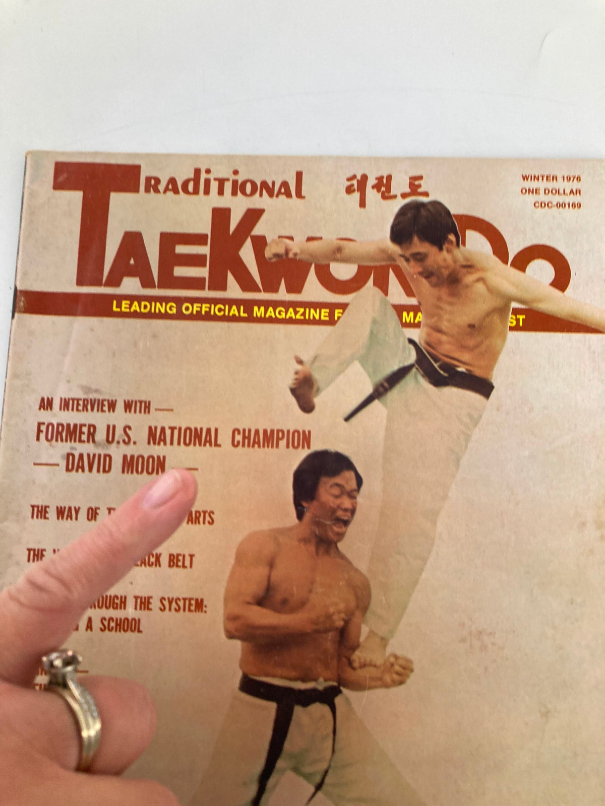 Close-up view of the cover of the Vintage Traditional Taekwondo Magazine Winter 1976 highlighting an interview with champion David Moon. The image captures the dynamic taekwondo action and features important topics such as martial arts training.