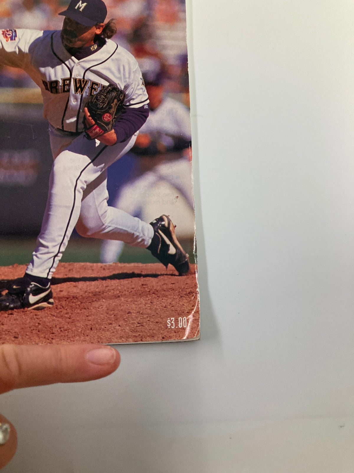 Close-up image of the 1998 MLB Milwaukee Brewers Official Spring Training Program showing a player pitching, with price tag of $3.00 visible.