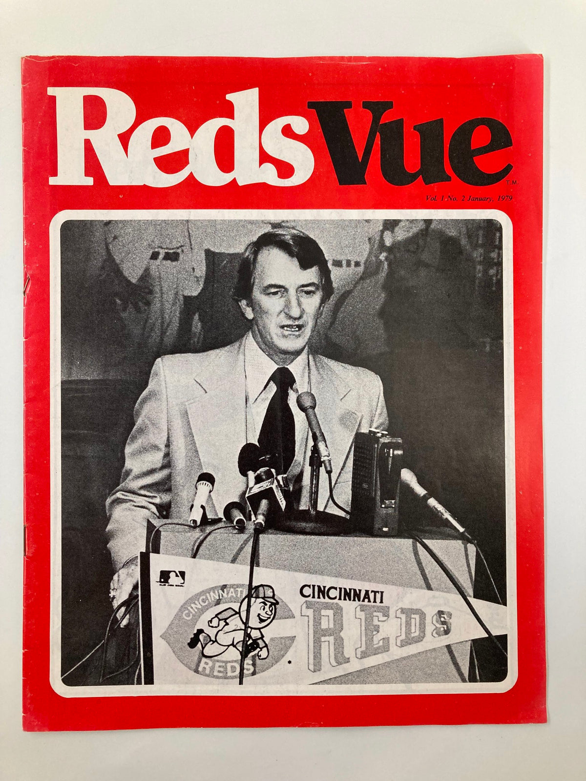 Cover of January 1979 Vol. 1 #2 MLB Cincinnati Reds RedsVue Official Program featuring a press conference image with a speaker and microphones.