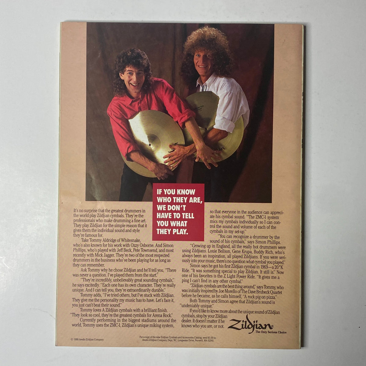 Zildjian advertisement featuring two drummers holding cymbals, as seen in Modern Drummer Magazine August 1988 with Joey Kramer on the cover. The image highlights the iconic cymbals and offers insight into drumming techniques, appealing to drumming enthusiasts.
