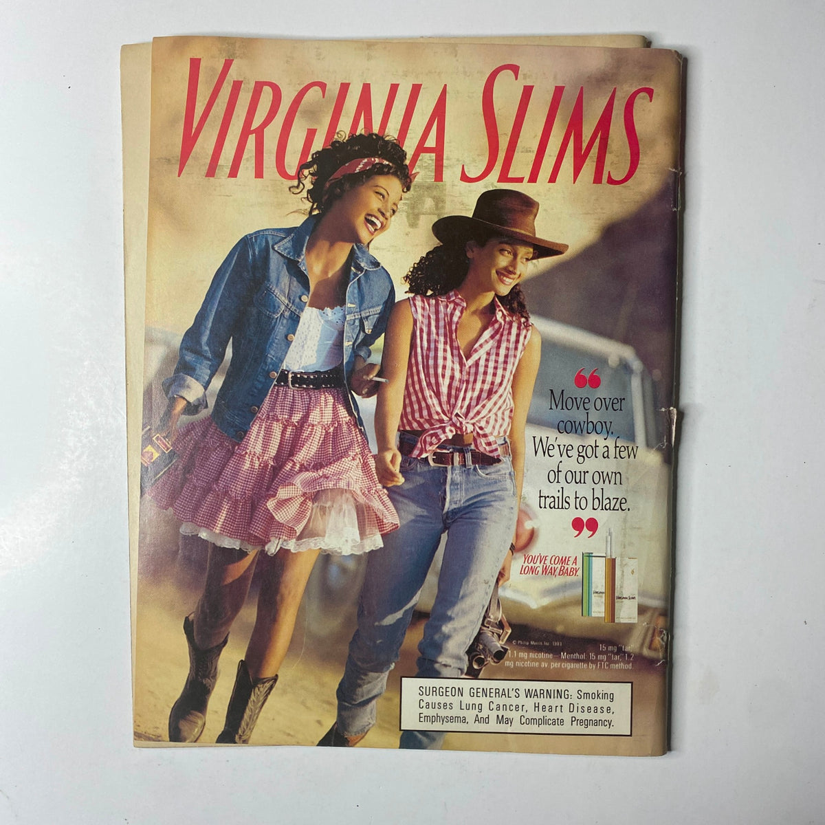 Virginia Slims advertisement featuring two women dressed in casual, stylish outfits, promoting trailblazing spirit, alongside the Ebony Magazine August 1993 The Modern Black Family issue.