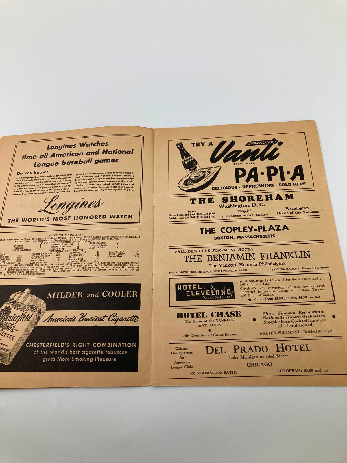 Inside view of the 1940 The Yankees American League Baseball Club Official Score Card displaying various advertisements for hotels and businesses, highlighting the era's marketing.