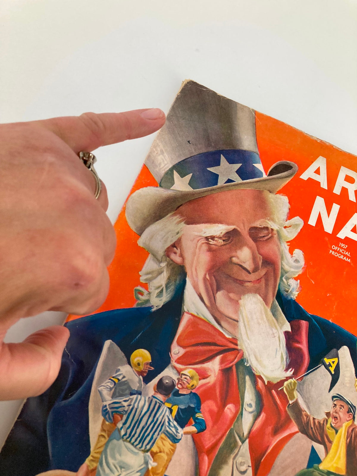 Close-up view of the 1940 NCAA Football Army vs Navy Official Program cover highlighting Uncle Sam and details of the illustration.
