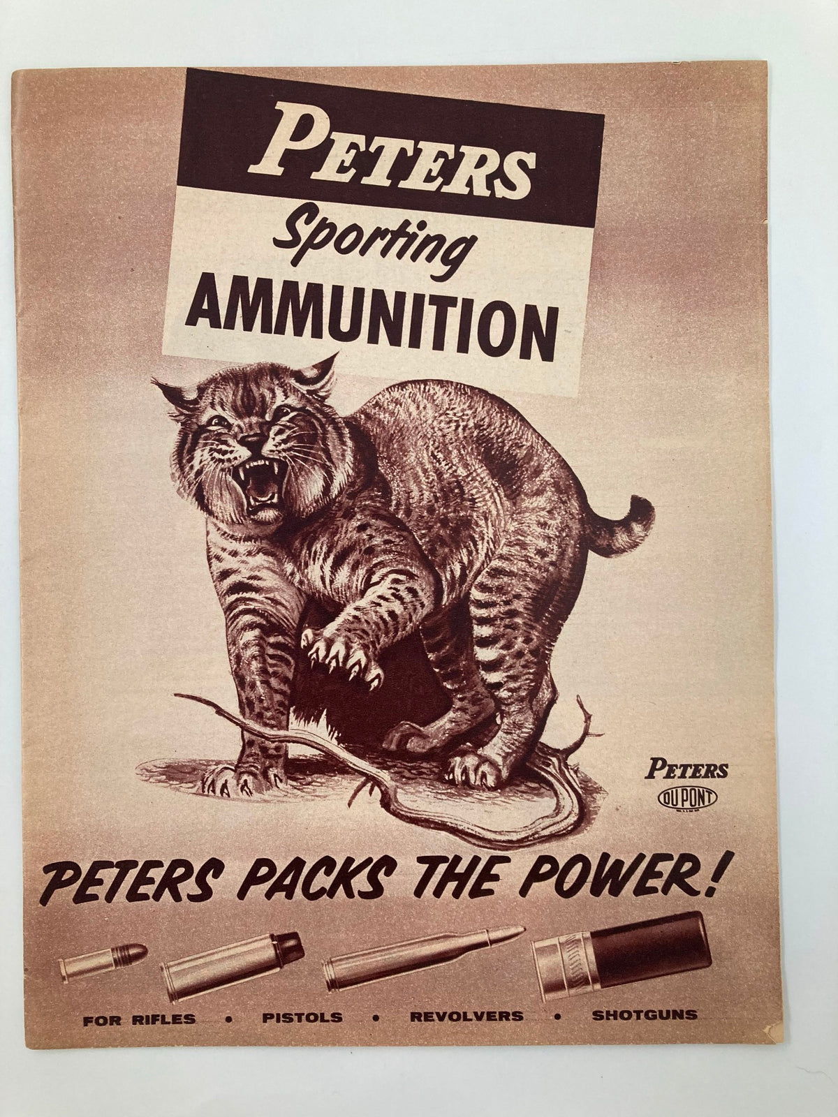 Vintage Peters Sporting Ammunition guide cover featuring a fierce cat illustration, showcasing various ammunition for rifles, pistols, revolvers, and shotguns, with the slogan 'Peters Packs the Power!'