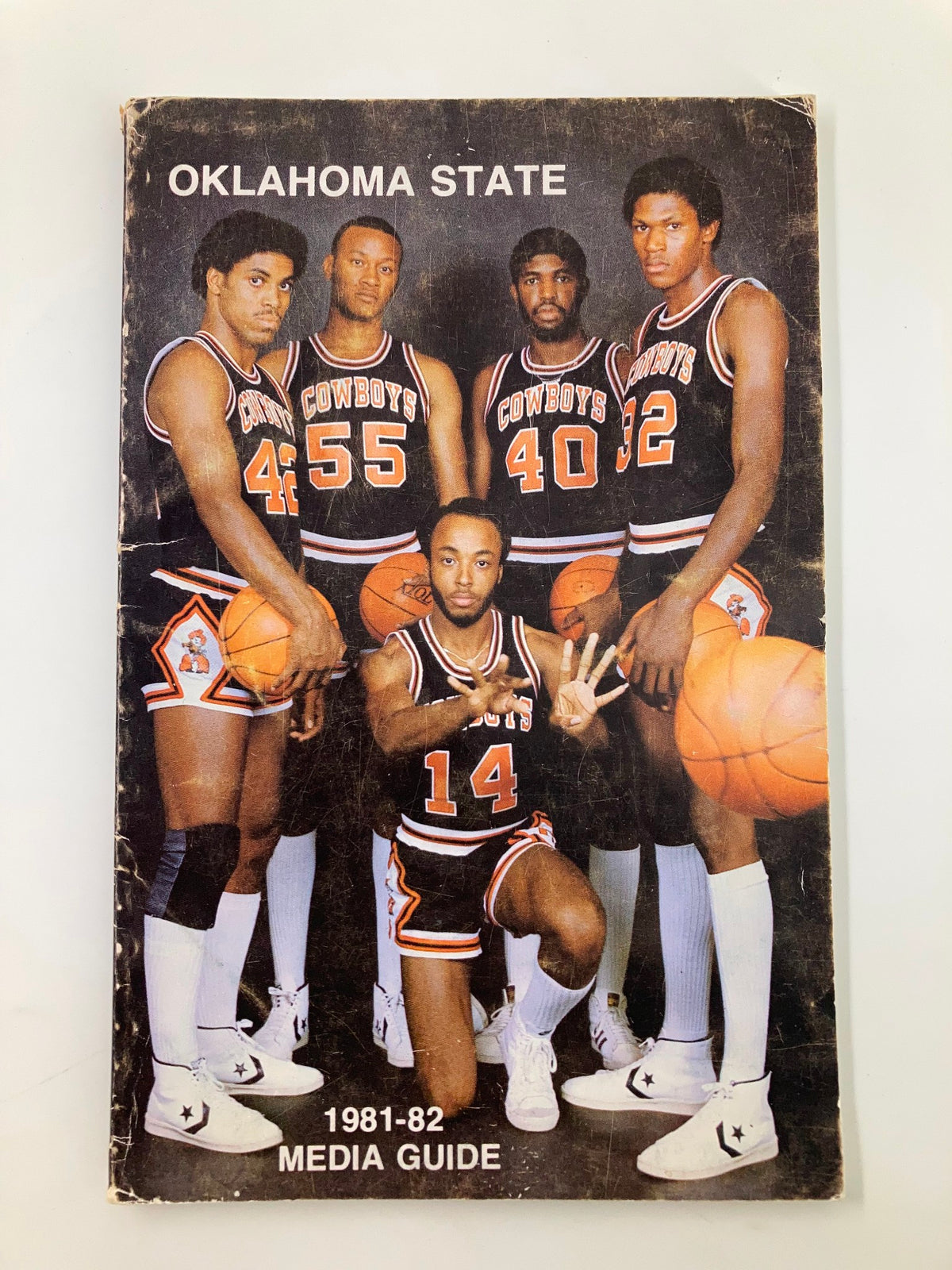 1981-1982 NCAA Basketball Oklahoma State University Cowboys Media Guide featuring five players in a team pose, showcasing the Oklahoma State Cowboys basketball uniforms and equipment.