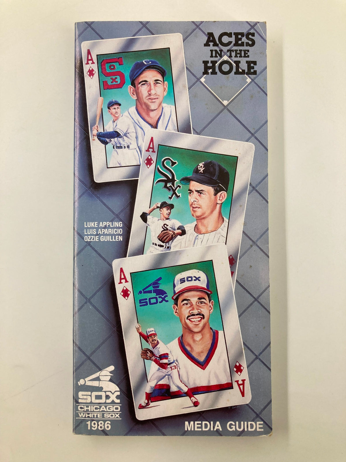 1986 MLB Chicago White Sox Media Guide Aces In The Hole featuring playing cards with Luke Appling, Luis Aparicio, and Ozzie Guillen, showcasing the team's iconic branding.