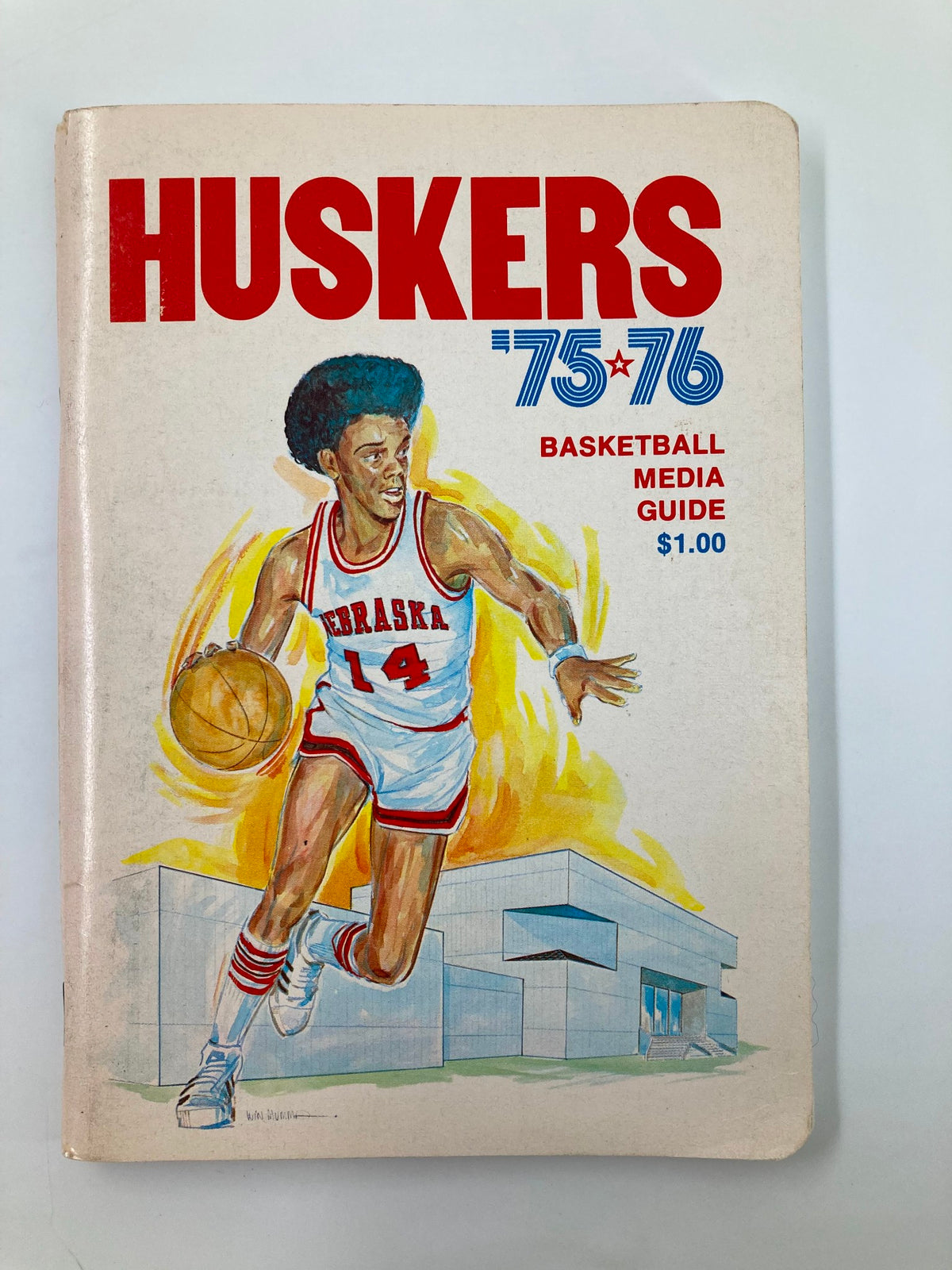 1975-1976 NCAA Nebraska Cornhuskers Basketball Media Guide featuring a vibrant illustration of a basketball player in action, showcasing the team's spirit and history.