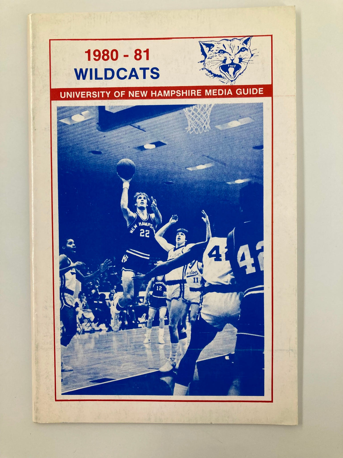 1980-1981 NCAA Basketball New Hampshire Wildcats Media Guide featuring a blue and white cover with a basketball player in action.