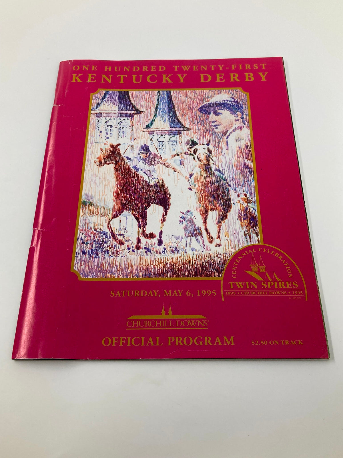 May 6 1995 121st Kentucky Derby Churchill Downs Official Program with vibrant cover art depicting horses and the twin spires, celebrating the historic event.