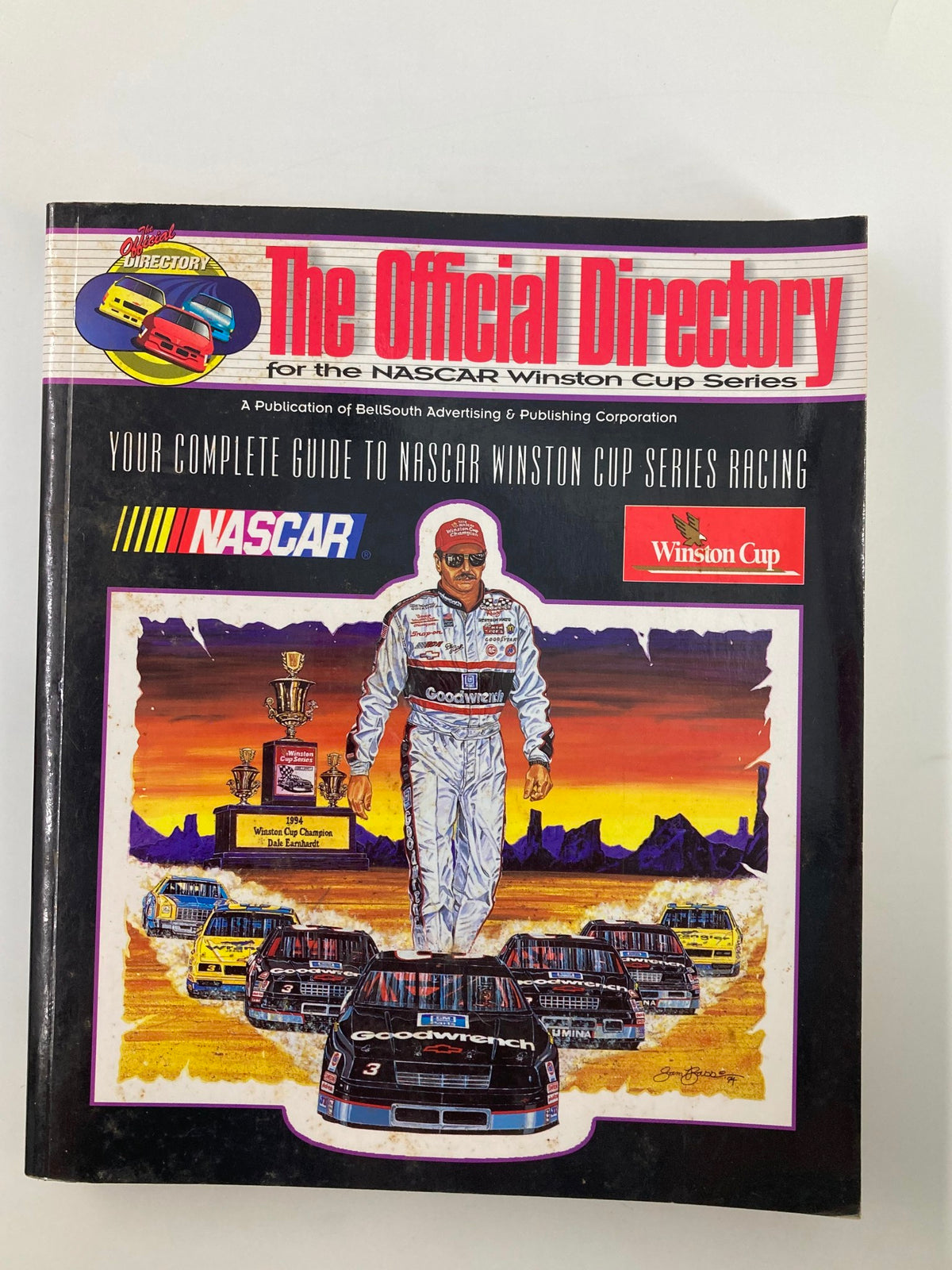 1995 The Official Directory for the NASCAR Winston Cup Series - Cover Image showcasing NASCAR racing cars and a driver holding a trophy.