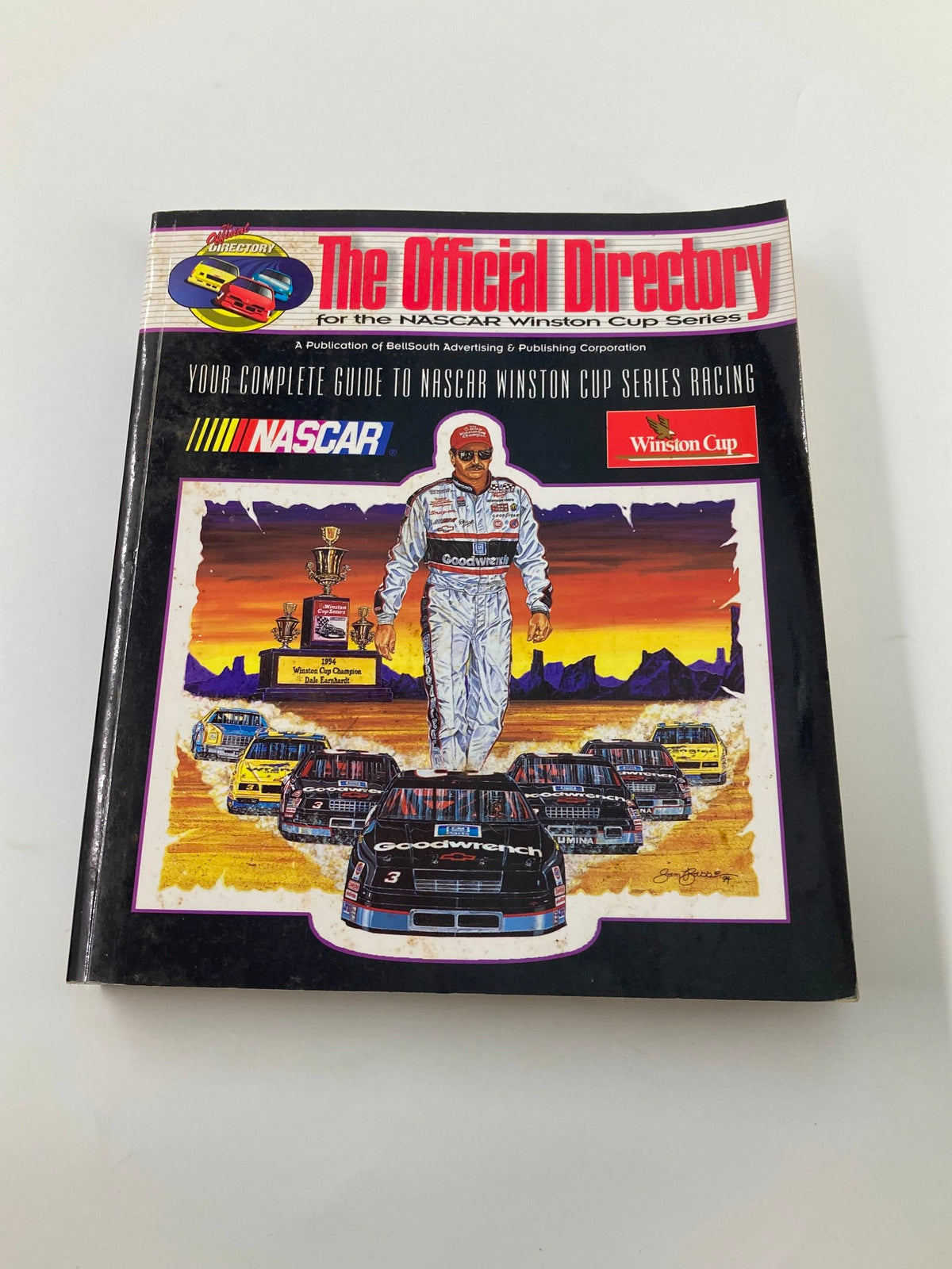 1995 The Official Directory for the NASCAR Winston Cup Series - Another angle of the cover featuring the iconic NASCAR driver with various racing cars in the background.