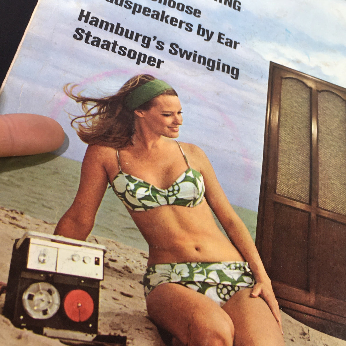 Detailed view of the cover of VTG High Fidelity Music Magazine, June 1967, featuring a woman smiling with a vintage audio device on the beach, showcasing Hamburg's Swinging Staatsoper.