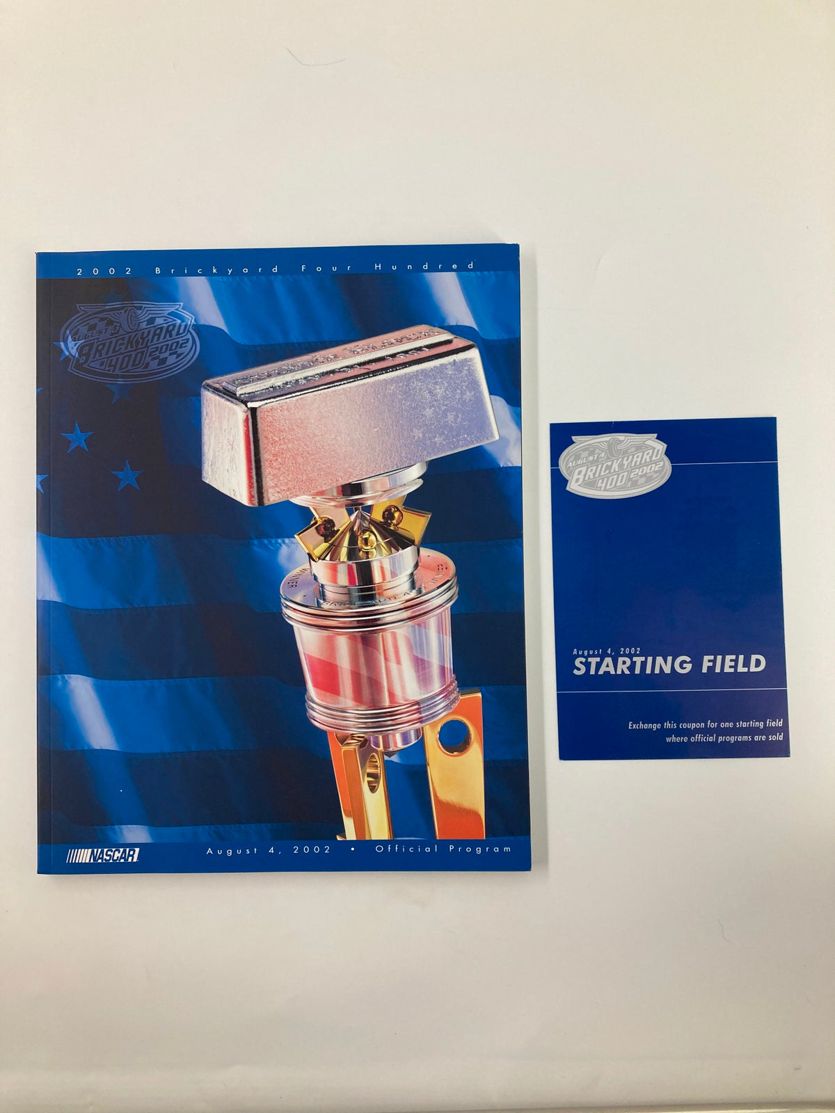 Official program cover for the August 4 2002 NASCAR Brickyard 400 Starting Field featuring a stylized trophy design.