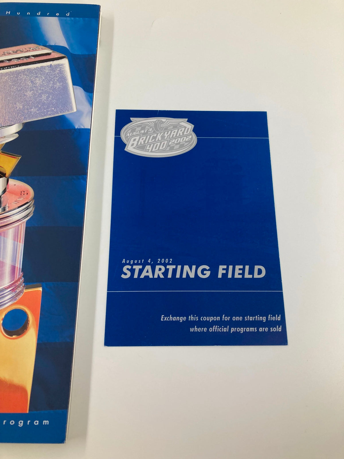 Coupon exchange page from the August 4 2002 NASCAR Brickyard 400 Starting Field Official Program, featuring instructions for obtaining a starting field.