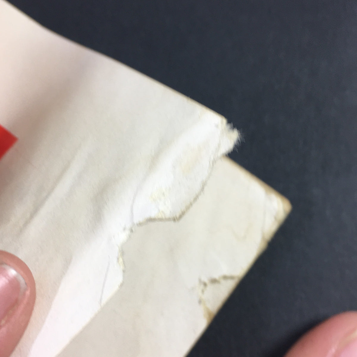Close-up view of the damaged corner of a page from VTG High Fidelity Music Magazine November 1956, illustrating wear and age.