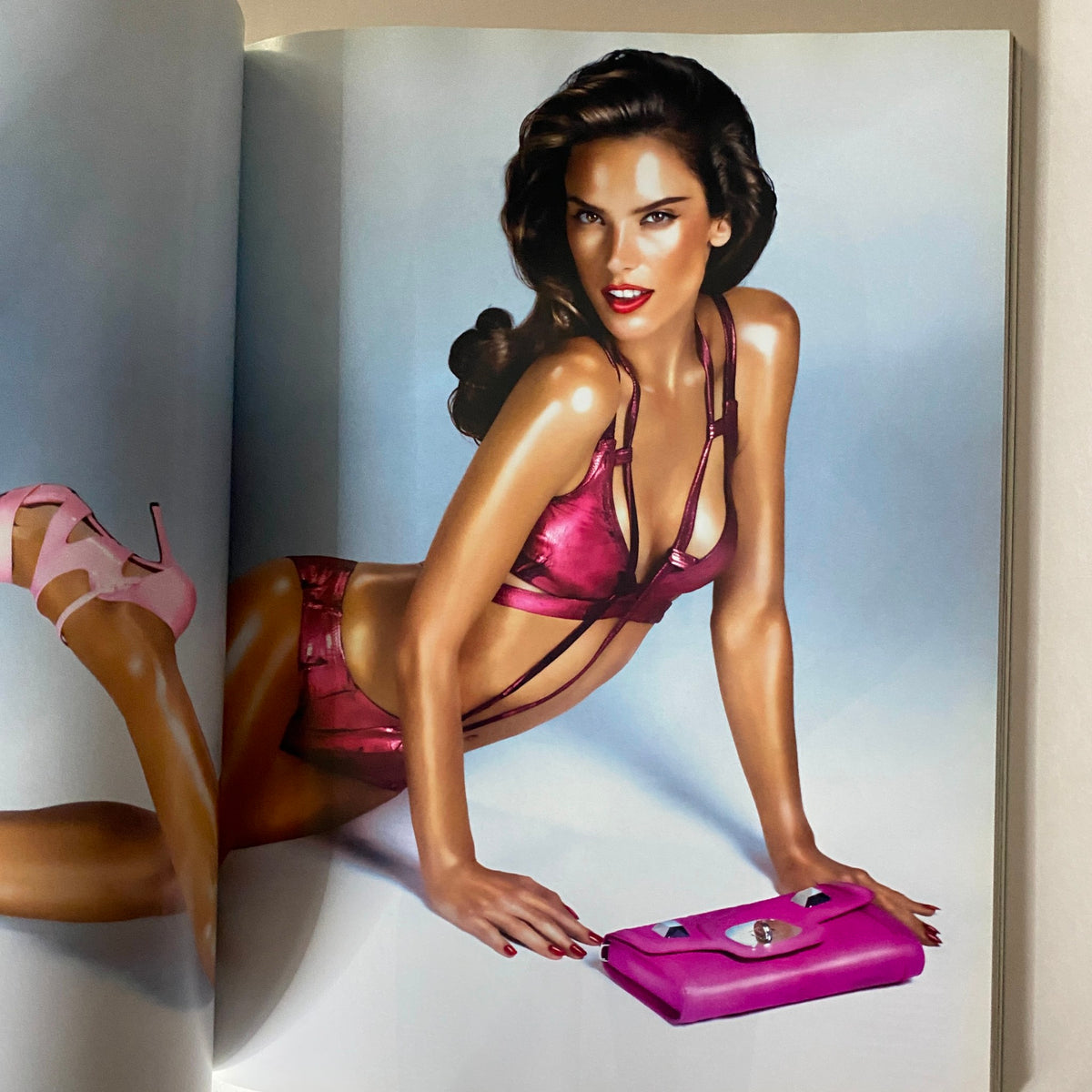 Fashion editorial image from Love Magazine displaying model in pink swimwear holding a pink accessory in Love Magazine 2011 Justin Bieber The Beautiful One No Label.