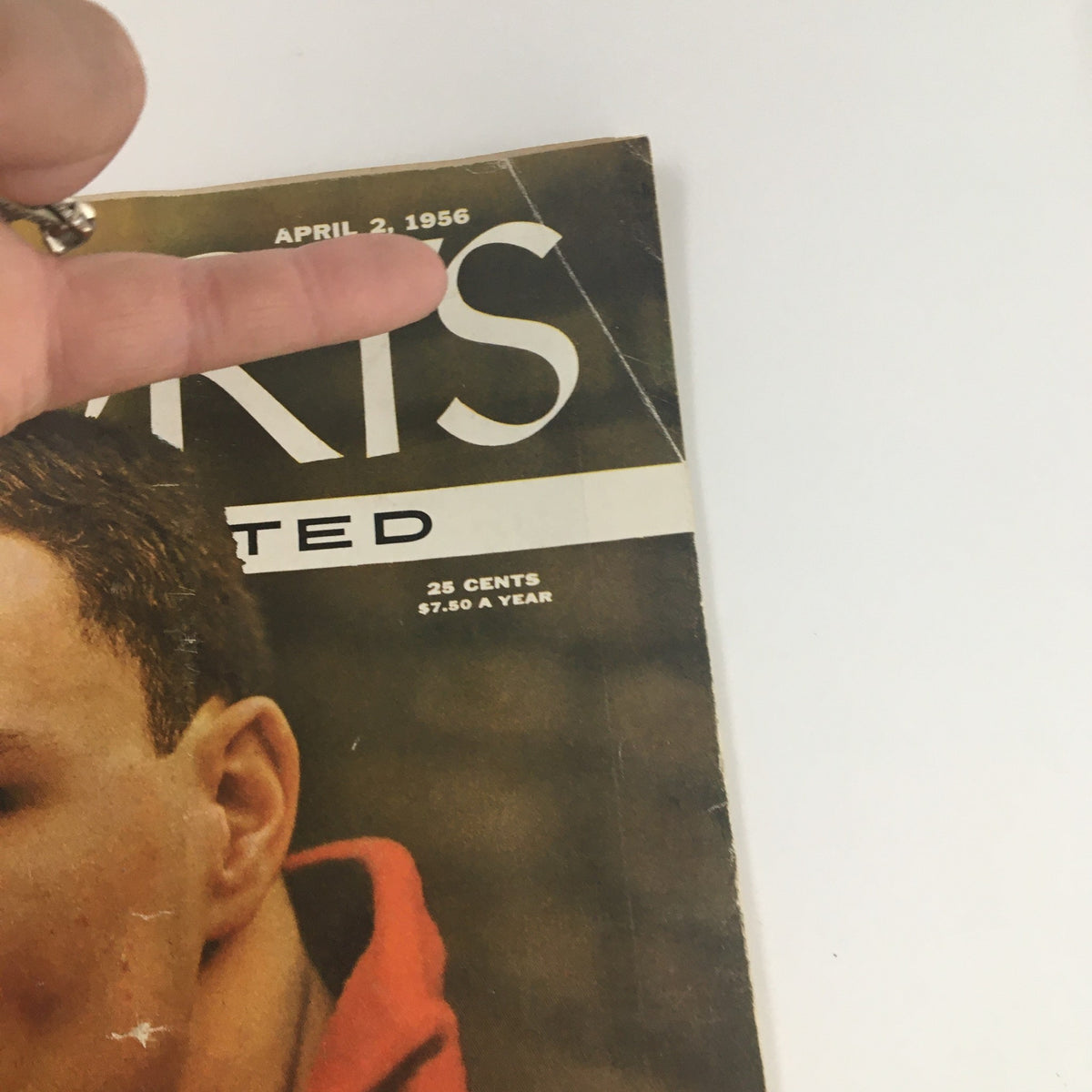 Close-up of the Sports Illustrated Magazine from April 2, 1956, highlighting the date and title with a focus on the cover featuring champion swimmer Al Wiggins.