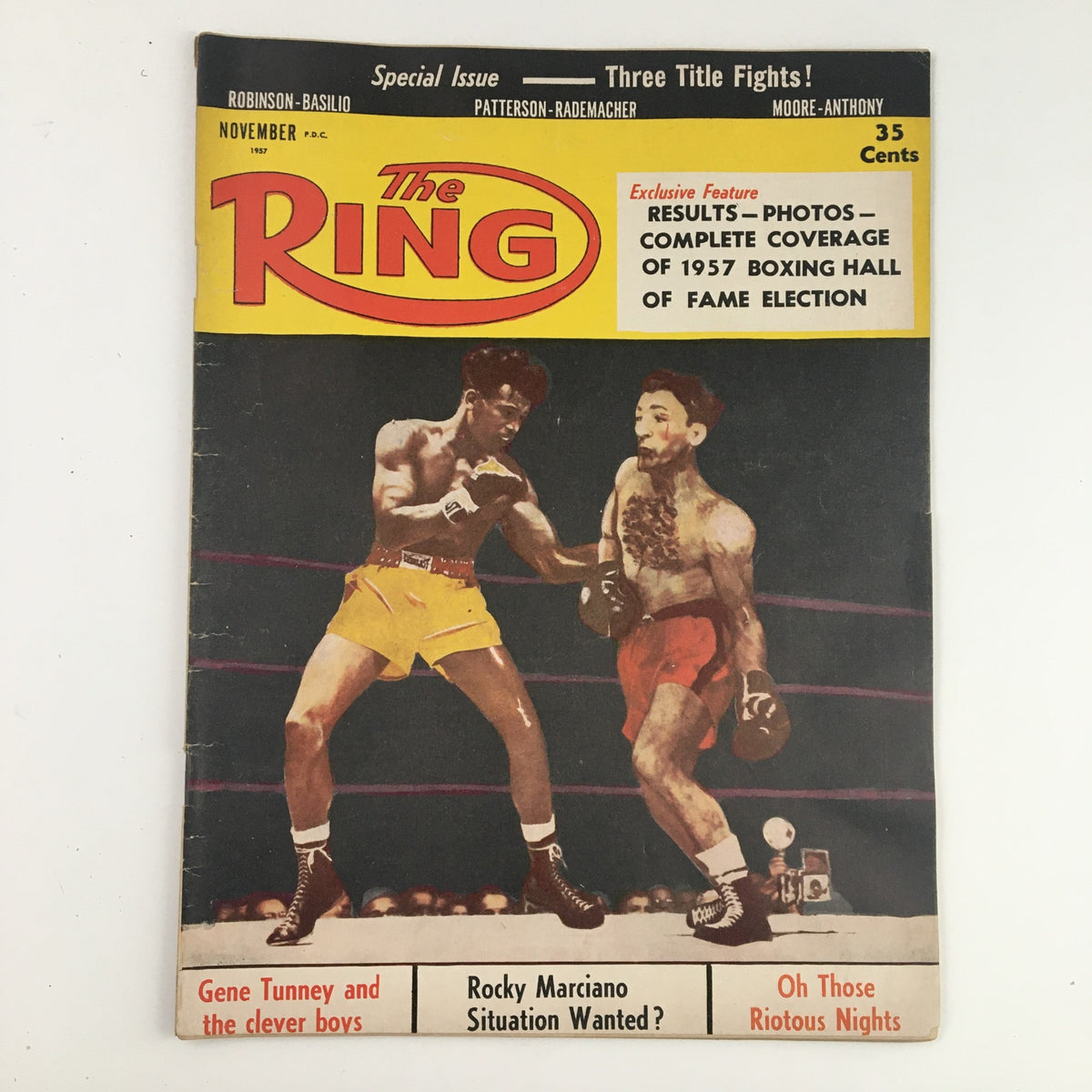 The Ring Boxing Magazine cover from November 1957 featuring the iconic match between Ray Robinson and Carmen Basilio, highlighting their fierce competition in boxing history.