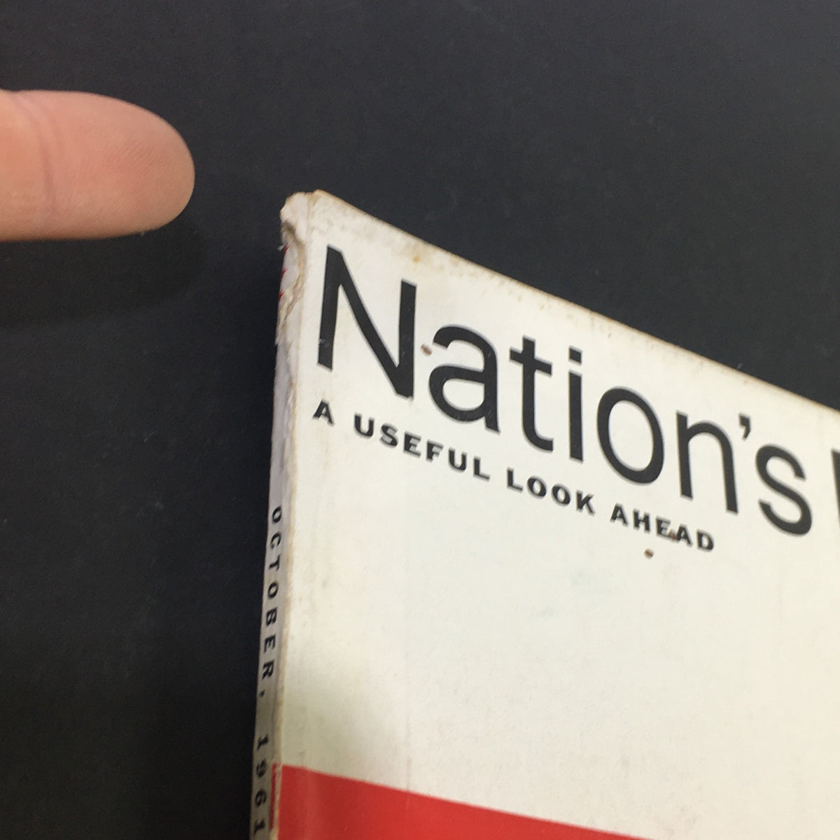 Close-up of the spine of VTG Nation's Business Magazine, October 1961, showing wear and a page numbering printed on the side.