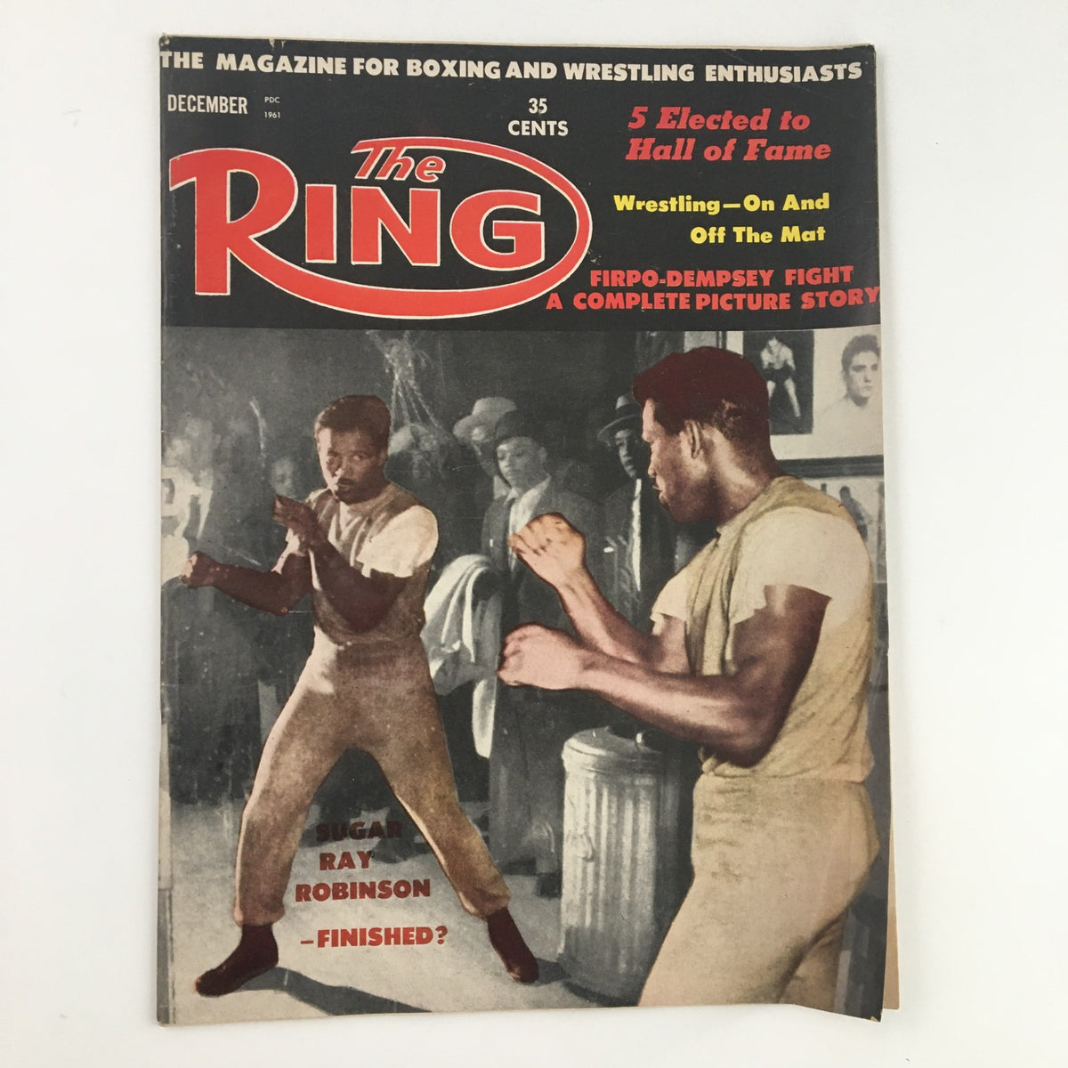 The Ring Boxing Magazine December 1961 cover featuring Sugar Ray Robinson, showcasing a vintage boxing scene and the magazine's vibrant header.