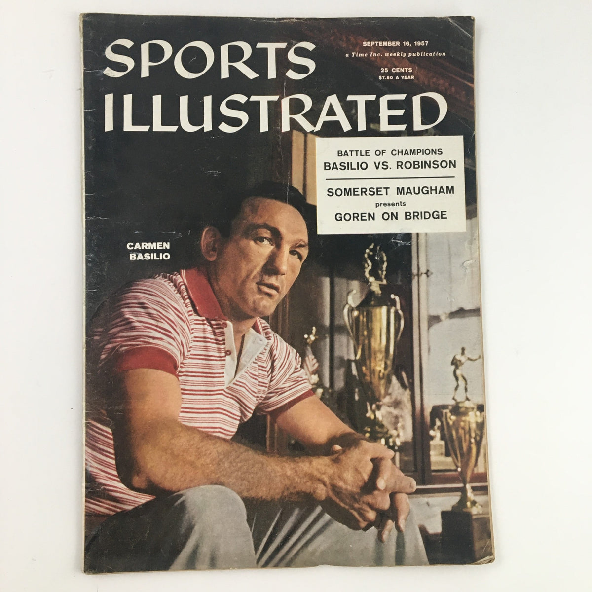 Sports Illustrated Magazine September 16 1957 featuring boxer Carmen Basilio on the cover, showcasing a vintage sports publication with a striking image of the athlete against the backdrop of trophies.