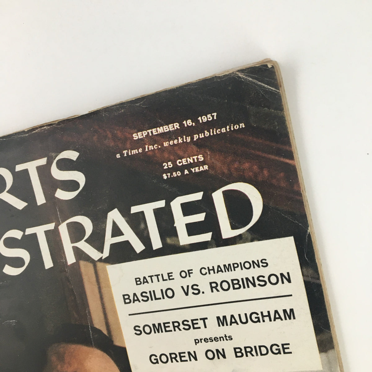 Close-up view of the Sports Illustrated Magazine September 16 1957 cover, highlighting the title and details such as 'Battle of Champions: Basilio vs. Robinson' for a glimpse into sports history.