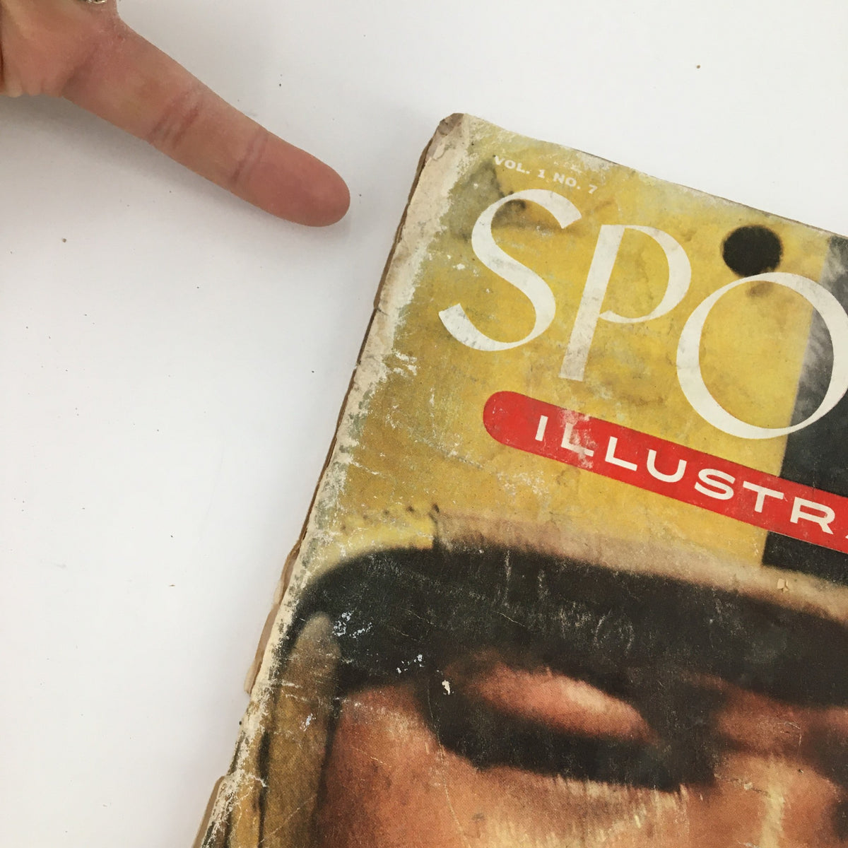 Detailed view of the top corner of Sports Illustrated Magazine September 27, 1954 featuring Calvin Jones, highlighting wear on the cover.