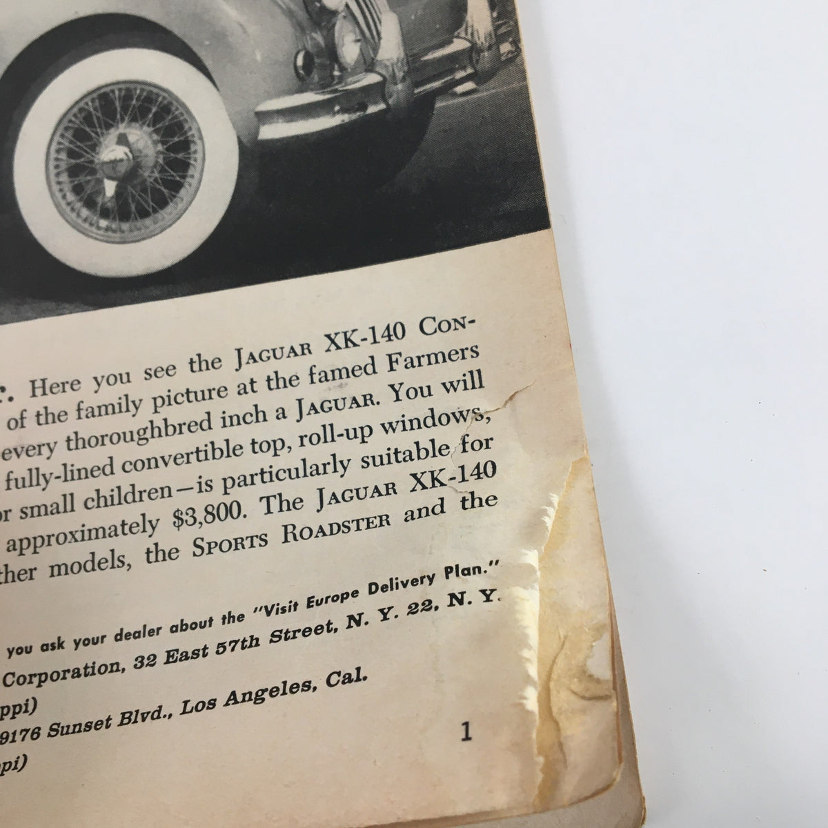 Back cover of Sports Illustrated Magazine March 5, 1956 featuring an advertisement for the Jaguar XK-140 convertible, showcasing a classic car.