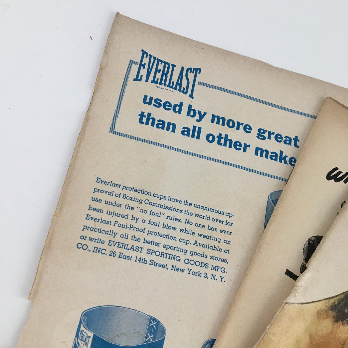 Everlast advertisement from The Ring Boxing Magazine June 1954, showcasing protective cups used in boxing. This image highlights the brand's endorsement, emphasizing its popularity in the sport.