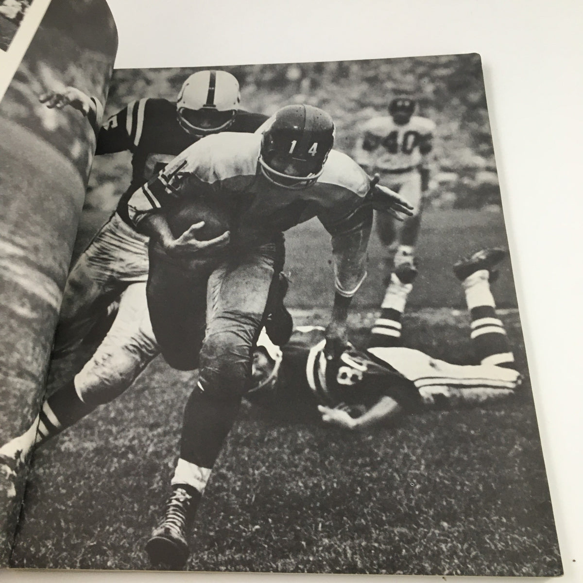 NFL Best Play of the Year 1963 Documentary - A black and white image capturing a football player in action, evading a tackle during a game.