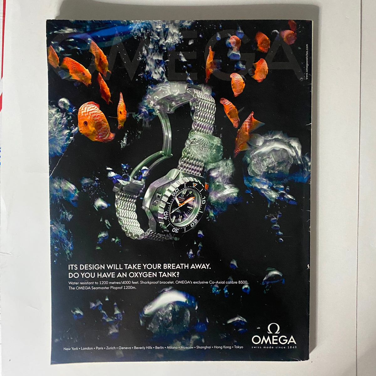 Back cover of Interview Magazine November 2009 featuring an advertisement for an Omega watch, set against a vibrant underwater scene.